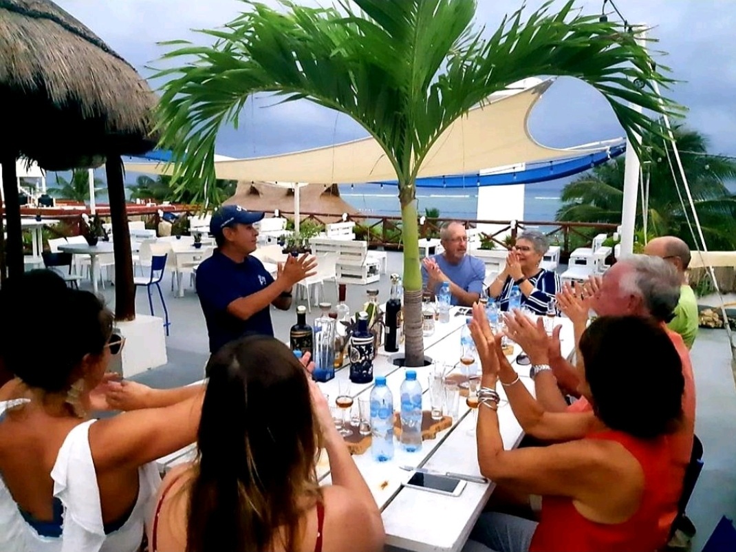 A group of students at Tequila University applaud the Maestro Tequilero during his presentation on the rooftop of La Sirena Puerto Morelos.
